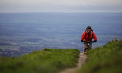Tobias Mews mountain biking along a trail in the North York Moors